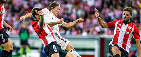 Real Madrid's Luka Modric vies with Inigo Martinez of Athletic Bilbao