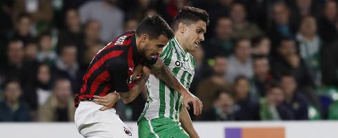 Milan's Suso vies with Marc Bartra of Real Betis