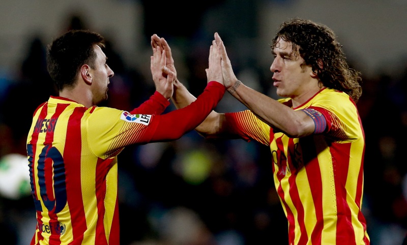 Lionel Messi and Carles Puyol