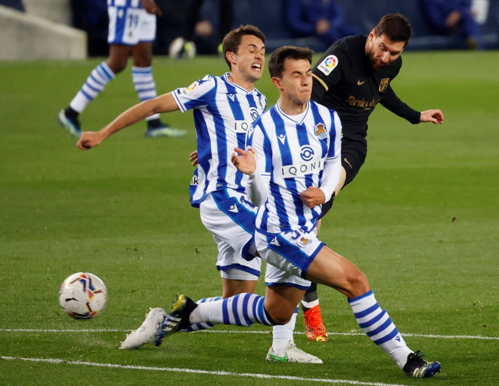 Real Sociedad s Martín Zubimendi (C) and Ander Guevara (L) in action against Argentinian Lionel Messi (R) of FC Barcelo