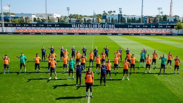 Valencia players stand with Mouctar Diakhaby