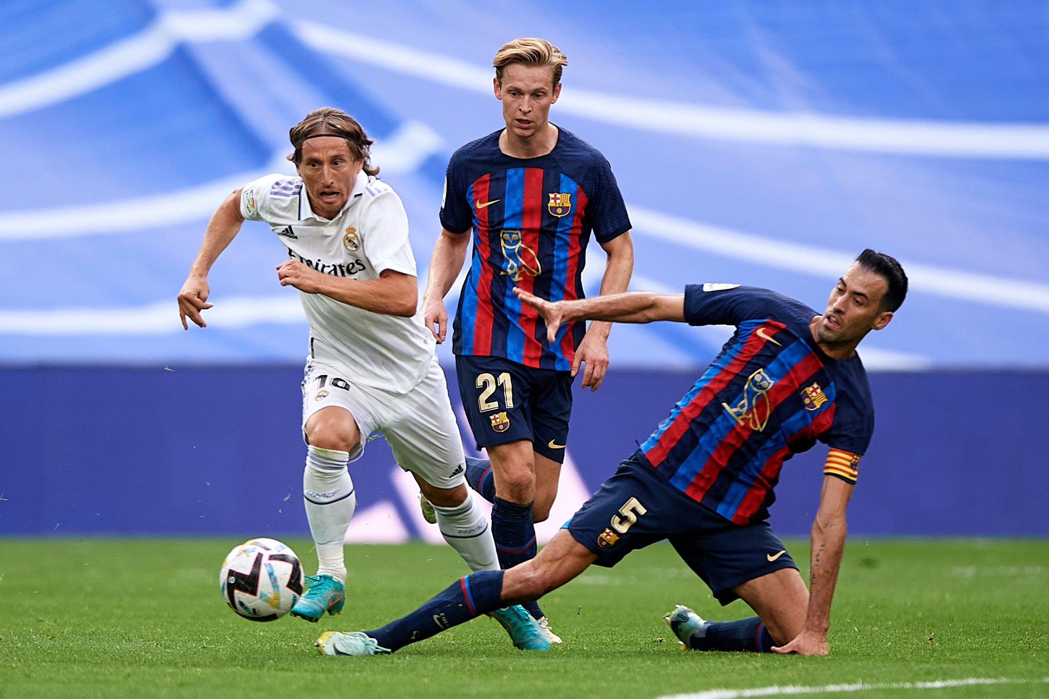 Real Madrid's Luka Modric, right, heads the ball past Manchester