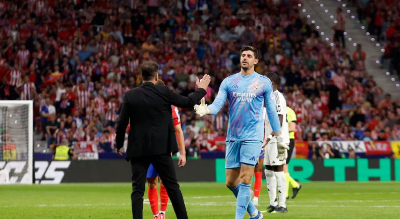 Courtois shakes hands with Simeone.