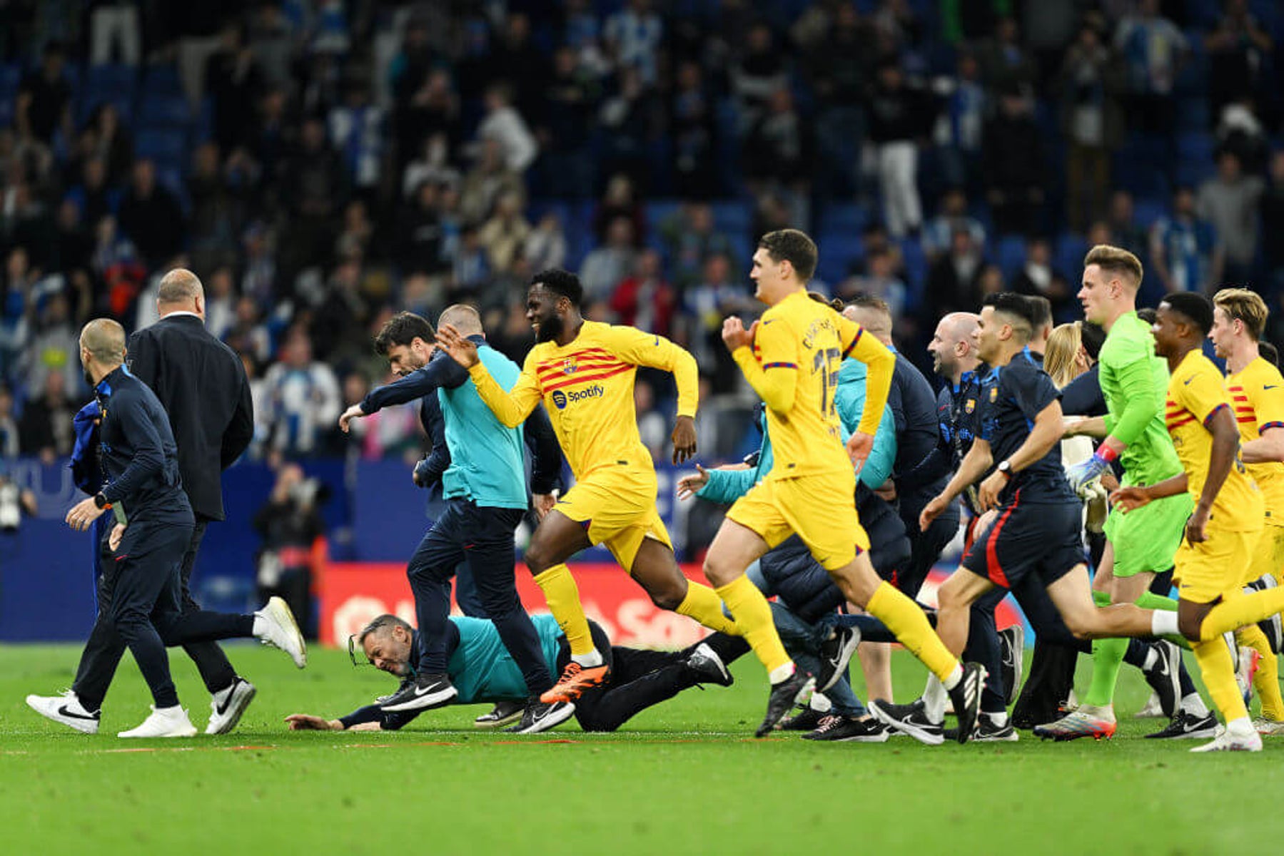 Barcelona are chased off the pitch by Espanyol fans.
